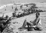 Navy SEAL Bob Meddo acts as a lifeguard during Marine exercises in Coronado while reservists land on the beach in June 1978. Rick McCarthy won honors in the 1979 World Press photo contest. Union-Tribune, photo by Rick McCarthy