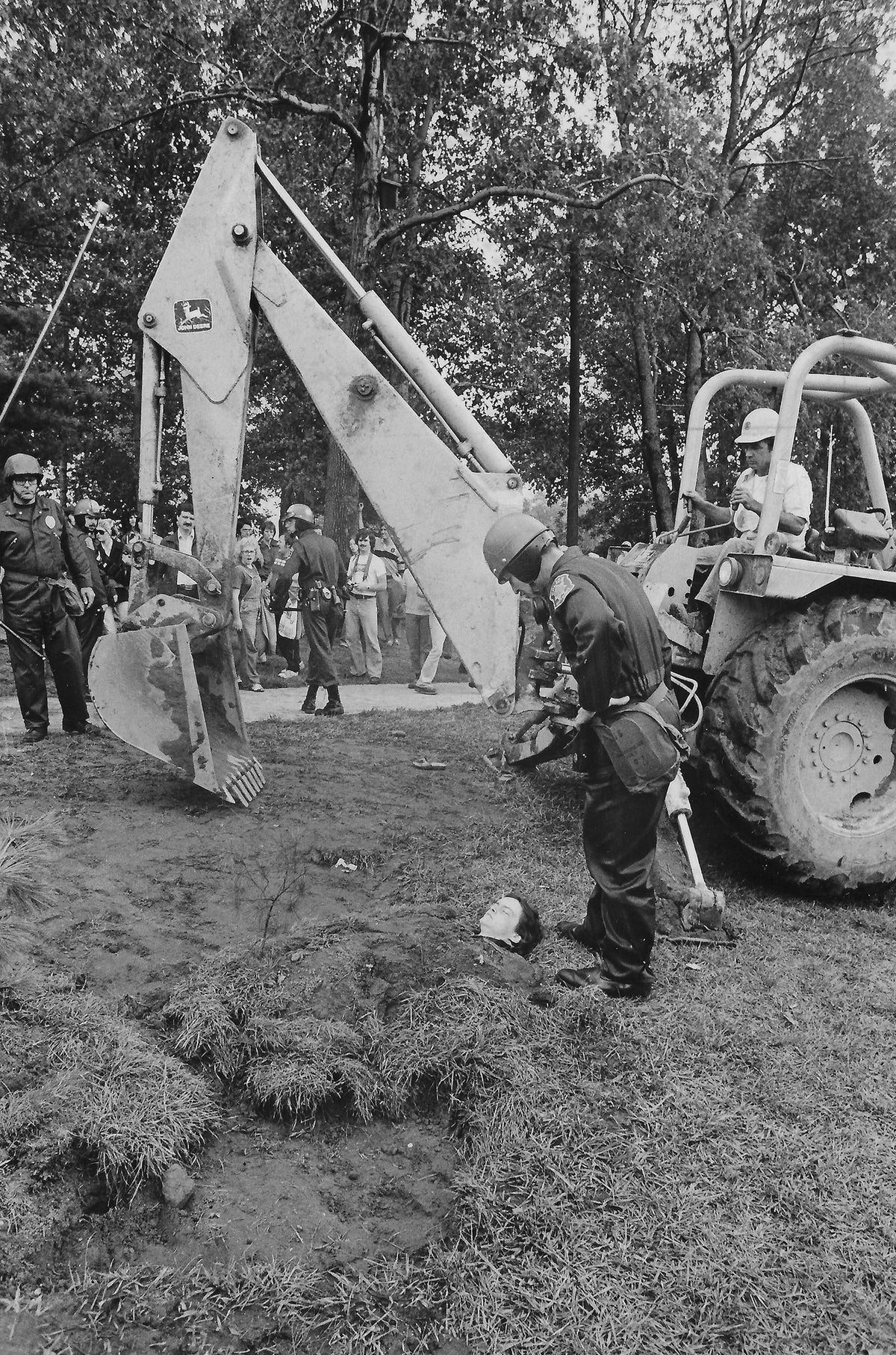 An unidentified protestor who was buried in a hole left behind by a tree removal on Sept. 7, 1977. Part of the “Tent City” protests at Kent State over the building of the Gym Annex. Courtesy Akron Beacon Journal