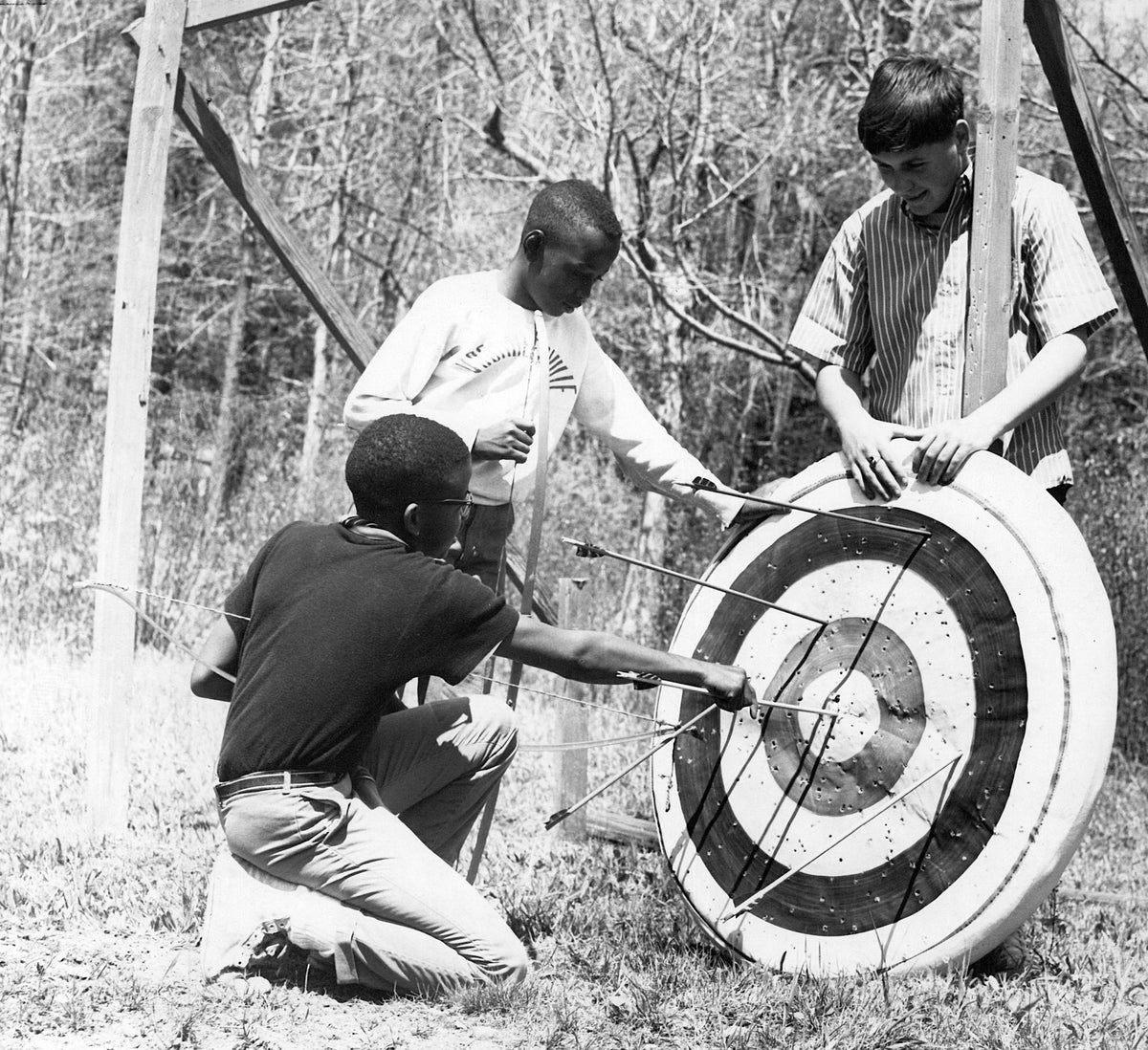 Kids removing their arrows from an archery target at Camp Thacher in Voorheesville, 1965. Courtesy Times Union Historic Images / Bud Hewig