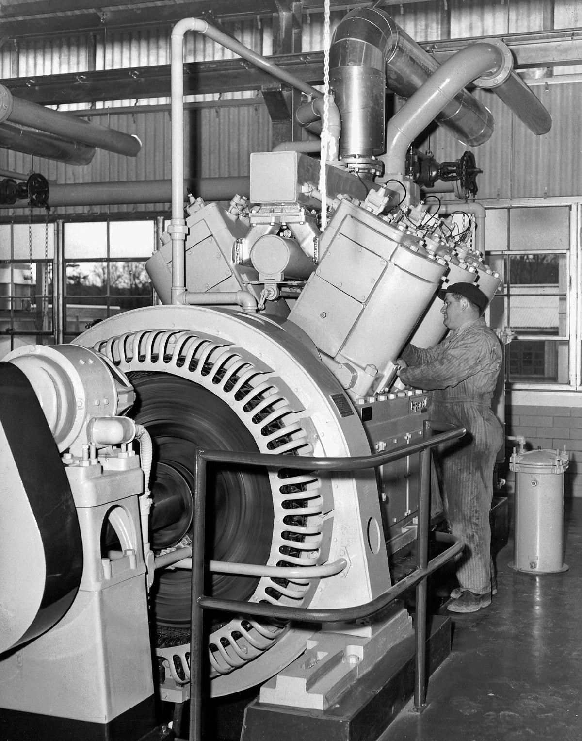 Plant repairman George Hatch working on an electric generator at Tennessee Gas Transmission Company near Nassau, 1953. Courtesy Times Union Historic Images