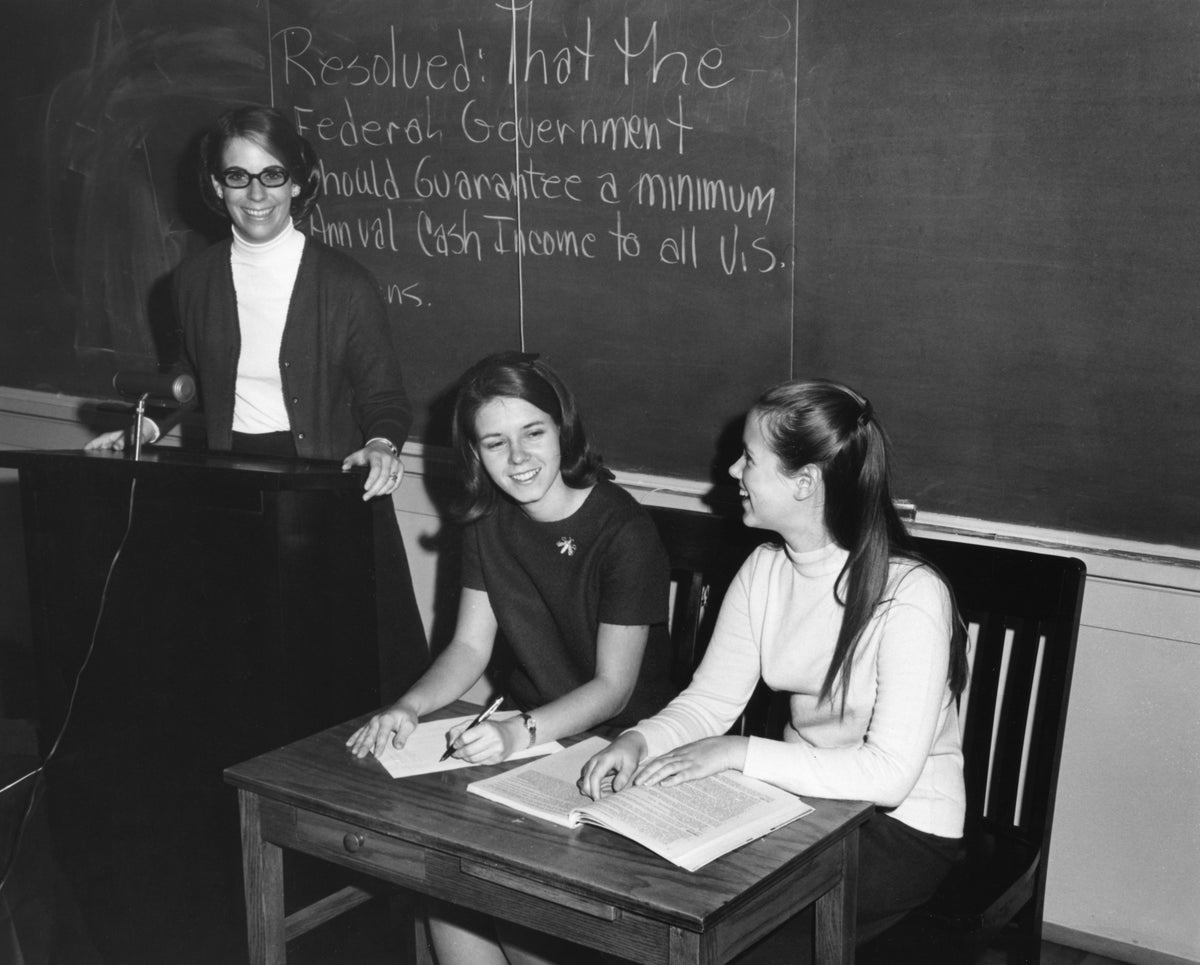 Members of the Mary Washington College Debate Team, 1968. Standing at the podium is Eleanor Woollard, the President of the team, and to her left are Martha Christian and Susan Stumpf. Courtesy University of Mary Washington, Special Collections & University Archives.