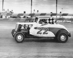 Bill Nicholson carrying the checkered flag after winning the Main Event at Englewood Speedway, Englewood, 1955. The first race at Englewood Speedway was held on Memorial Day 1947, and the grand opening on June 15 of that same year. COURTESY SANDY NEELY