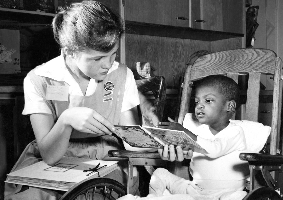 A volunteer reading to a patient at Decatur and Macon County Hospital, circa 1955. Courtesy Decatur Memorial Hospital