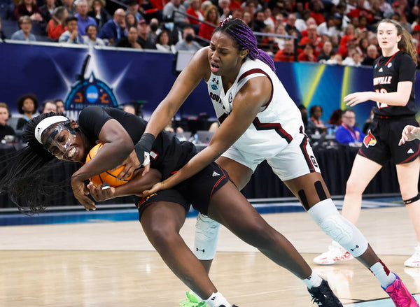 South Carolina’s Aliyah Boston (4) and Louisville’s Olivia Cochran (44) tussle for a ball during the Final Four semifinals at the Target Center in Minneapolis, April 1, 2022. Tracy Glantz / The State